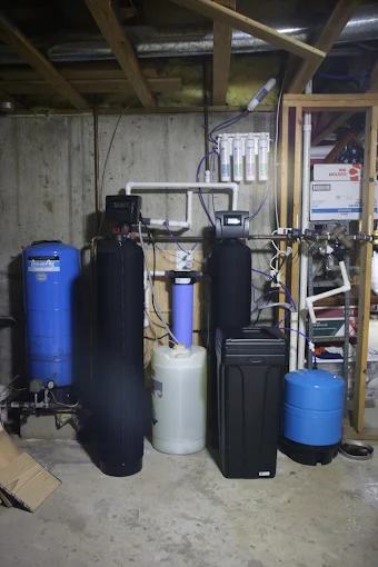 Complete well water treatment system in Lexington, IL including Greensand+ iron and arsenic filter, Ecomix-C softener, hydrogen peroxide injection, and certified RO, installed by Water Air and You